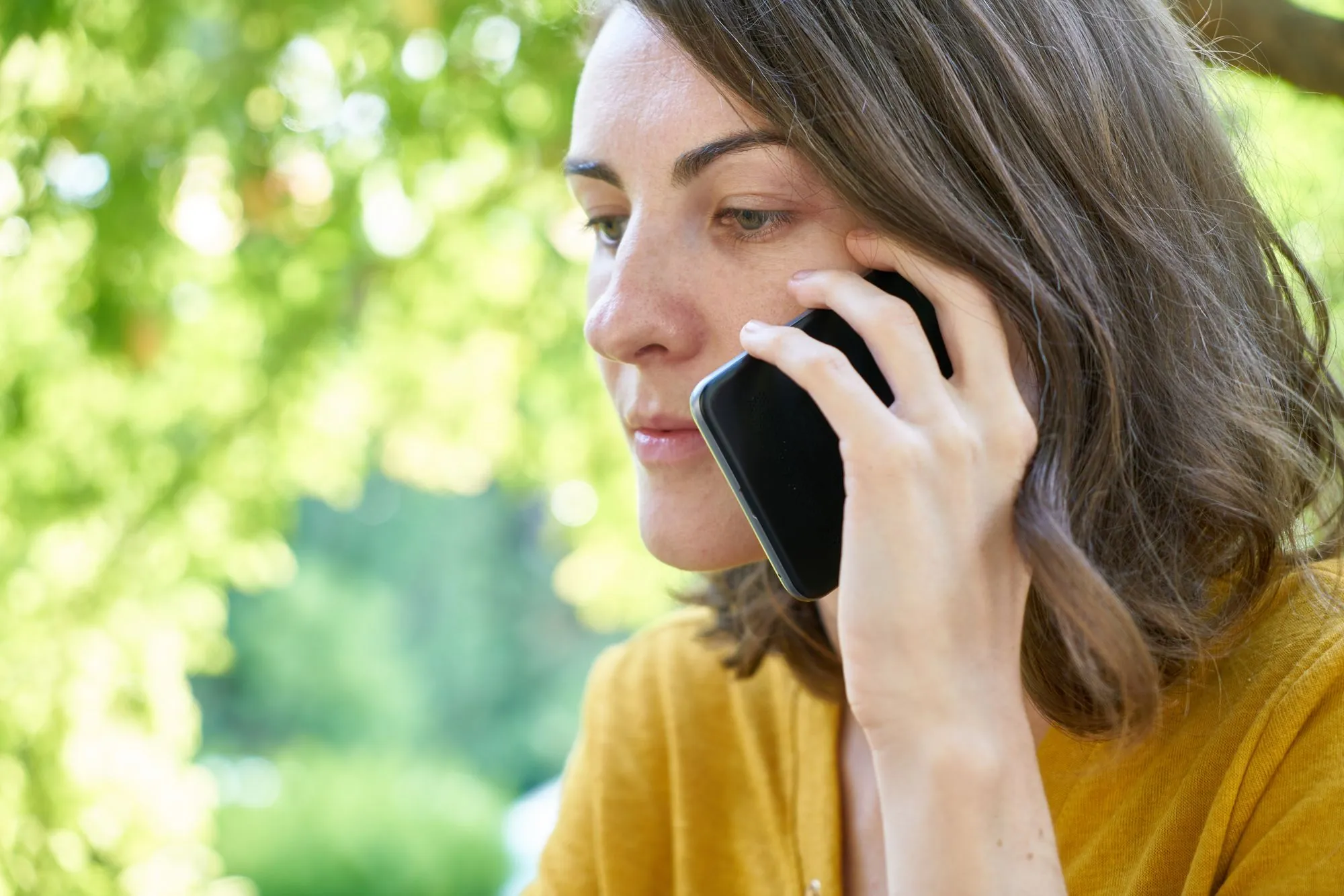 Someone making a phone call outdoors