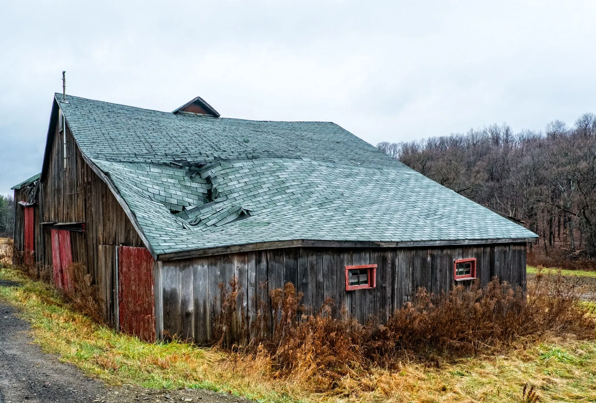 A roof covering damaged across a whole slope
